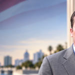 Andy G. Strickland, immigration attorney in St. Petersburg, Florida, with an American flag and courthouse background